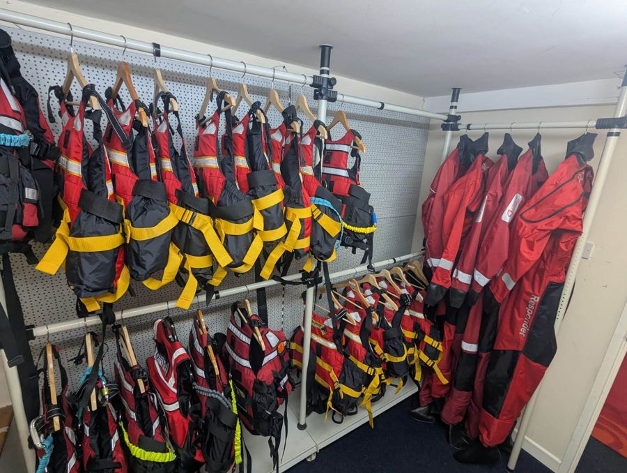 Racks of drysuits and lifejackets in the Tees River Rescue kit room